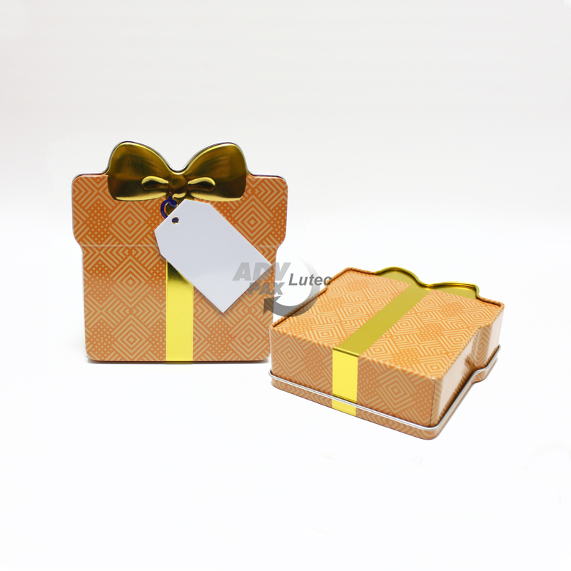Schmuckdose Geschenkdose orangenes Muster mit goldener stilisierter Schleife, Weißblechdose Draufsicht stehend, zweite Dose liegend, Rückseite