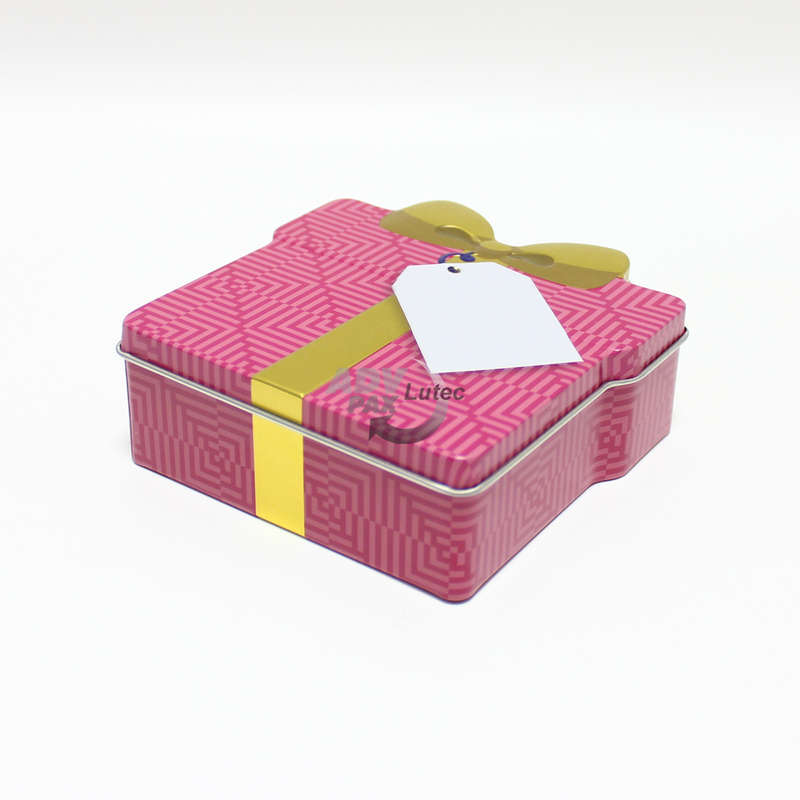 Schmuckdose Geschenkdose pink mit goldener stilisierter Schleife, Weißblechdose Ansicht liegend, Deckel und Höhe gut sichtbar